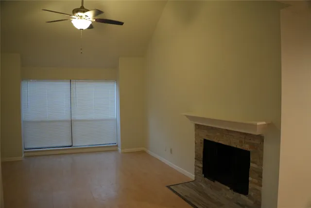 a view of a livingroom with an empty space and a fireplace