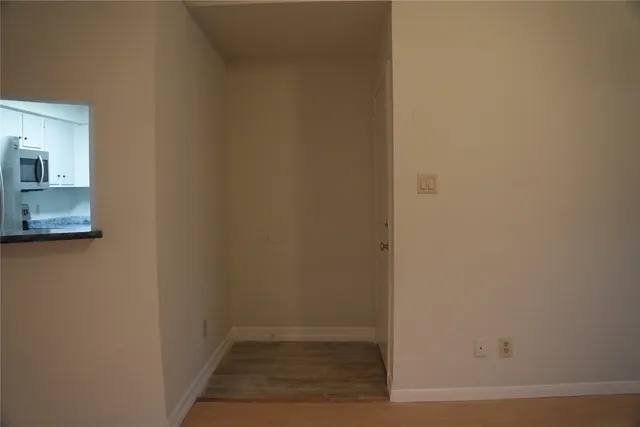 a view of a small space with wooden floor