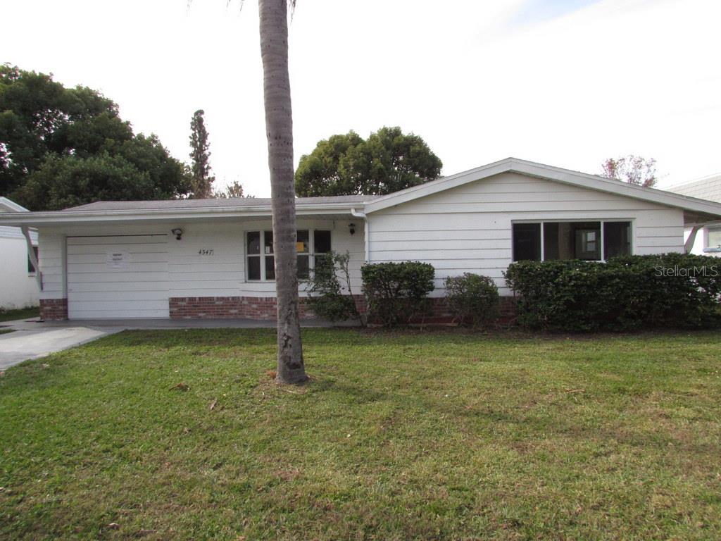 4347 Newbury Drive New Port Richey, FL 34652 - Photo 1 of 1 a view of a house with a yard and a garden
