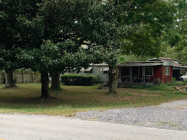 a front view of a house with a yard garage and trees