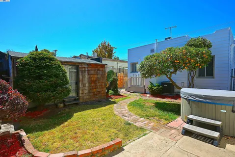 a view of a backyard with plants and a patio