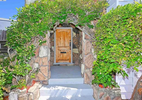 a pathway of a house with a yard