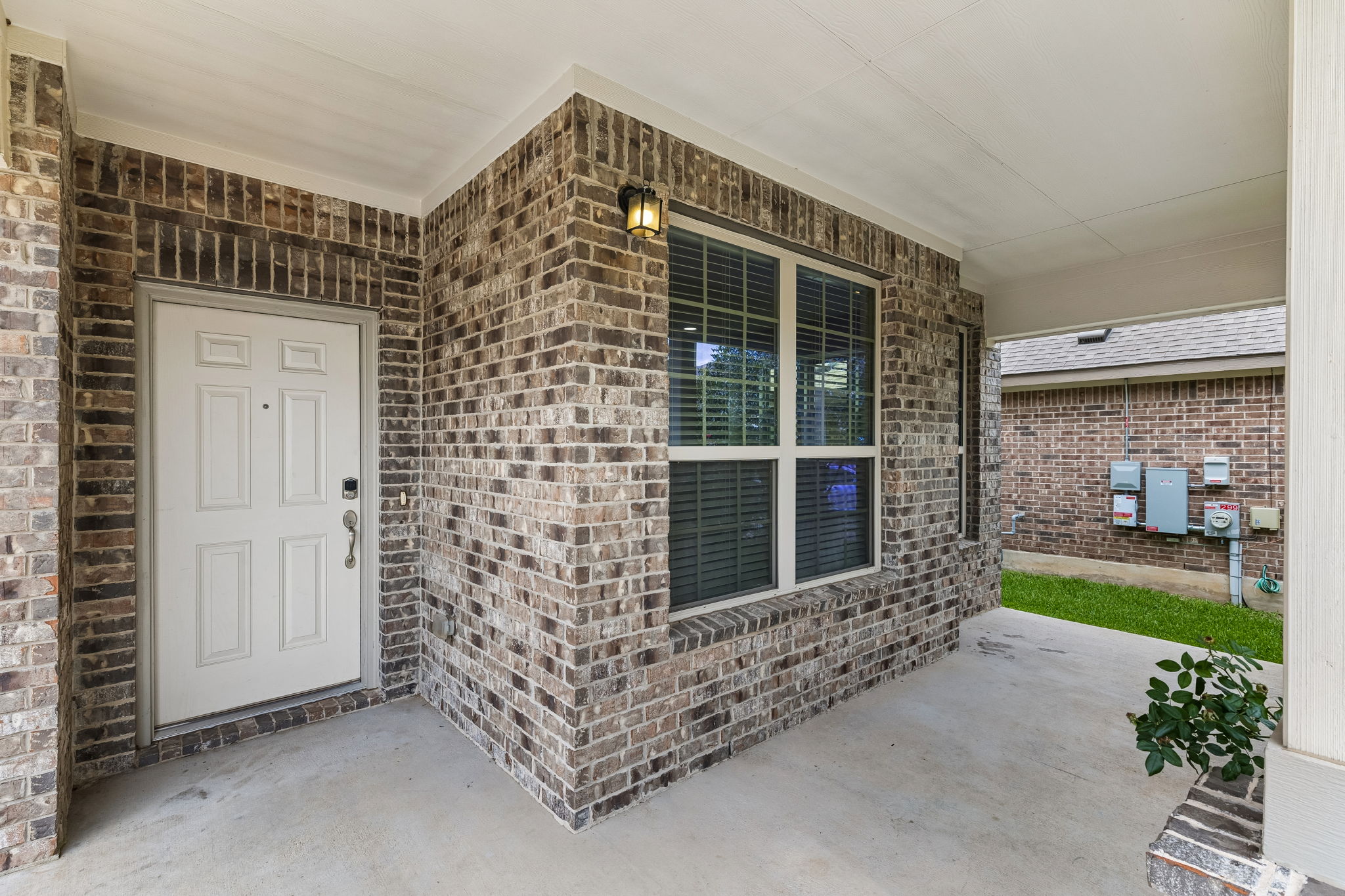 301 Rimrock Court Bastrop, TX 78602 - Photo 2 of 21 A welcoming front porch features sturdy brick construction and ample natural light.