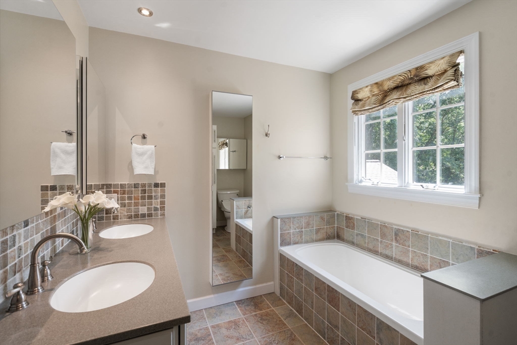 24 Russett Hill Road Sherborn, MA 01770 - Photo 26 of 39 a bathroom with a granite countertop tub sink and mirror