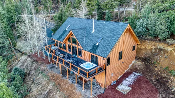 a aerial view of a house with balcony and trees