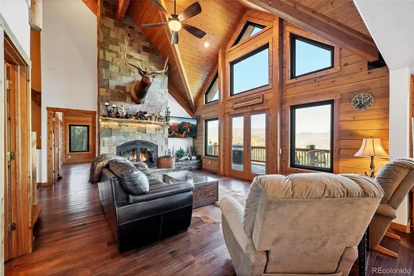 a living room with furniture a fireplace and a large window