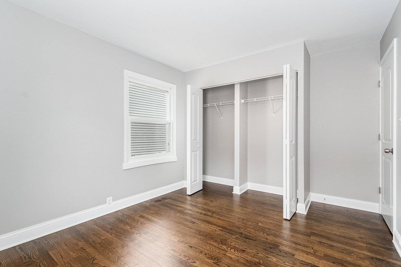 626 Iola Avenue Romeoville, IL 60446 - Photo 13 of 19 an empty room with wooden floor and windows