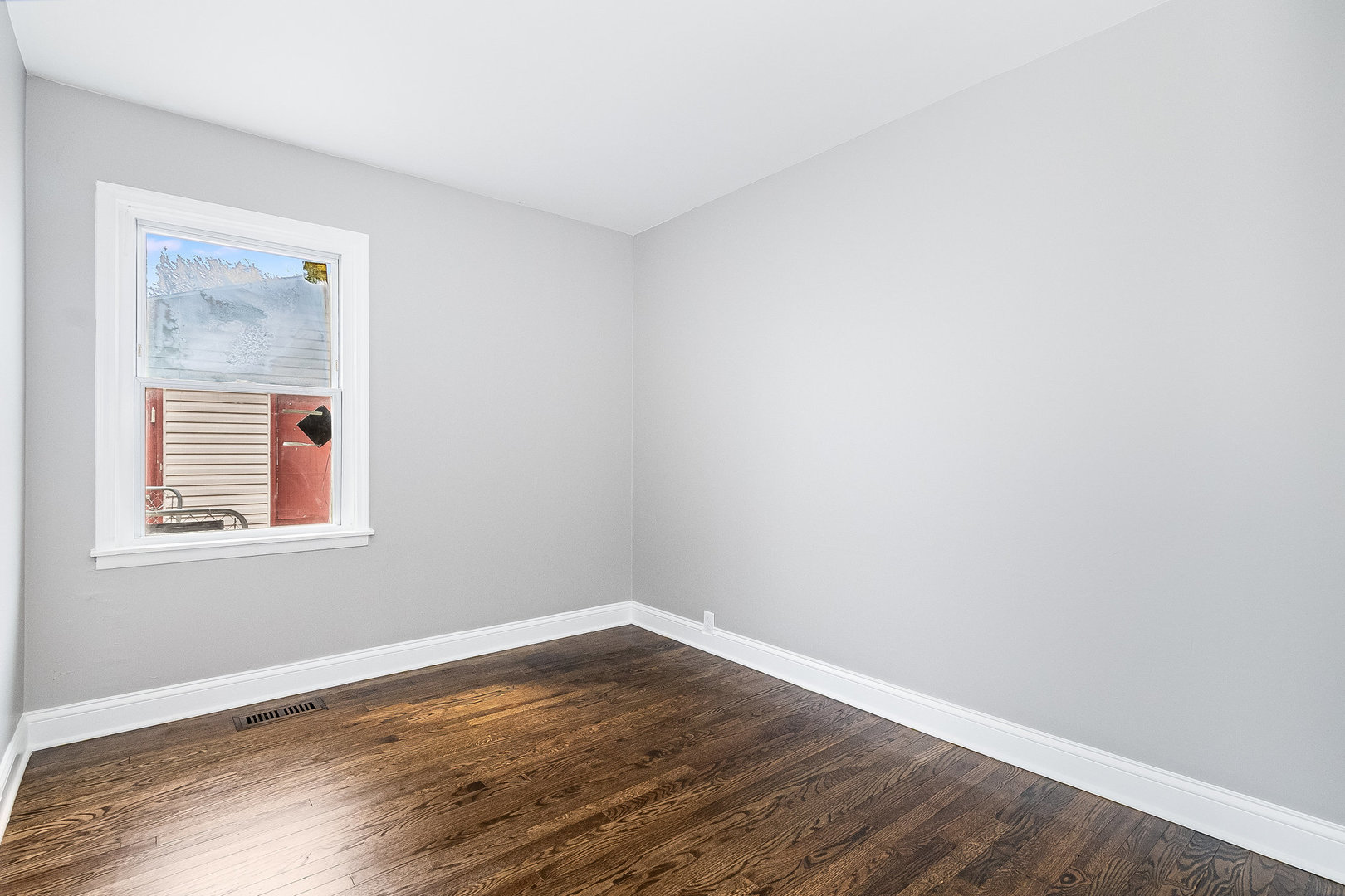 626 Iola Avenue Romeoville, IL 60446 - Photo 14 of 19 an empty room with wooden floor and windows
