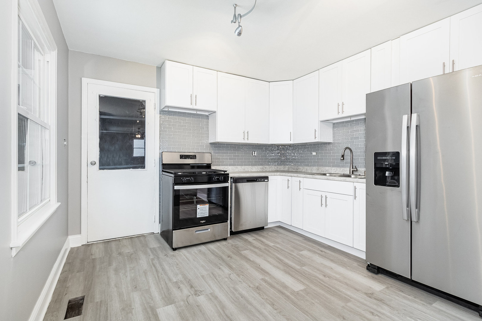 626 Iola Avenue Romeoville, IL 60446 - Photo 3 of 19 a kitchen with a refrigerator and a stove top oven