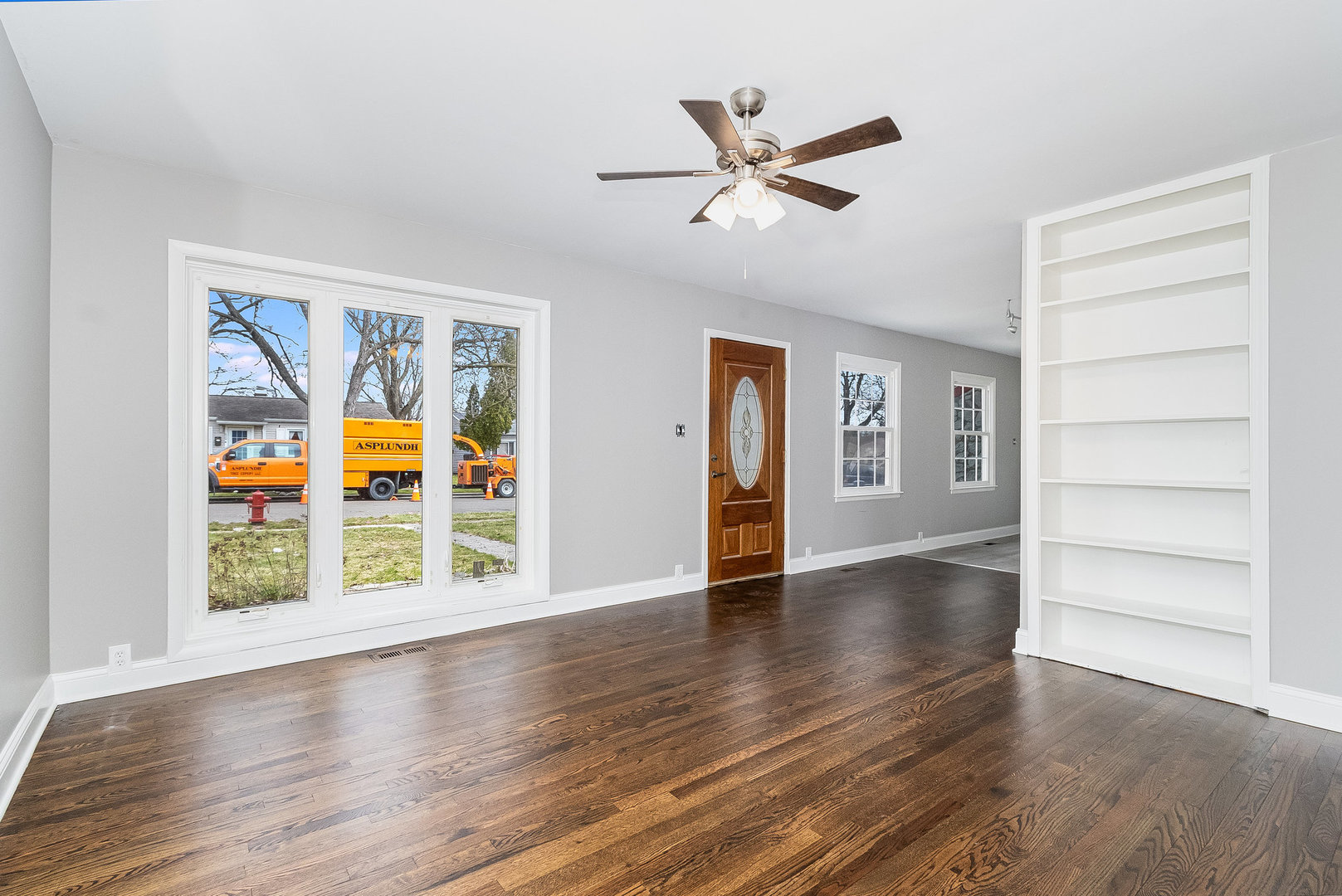 626 Iola Avenue Romeoville, IL 60446 - Photo 7 of 19 a view of an empty room with a window and wooden floor
