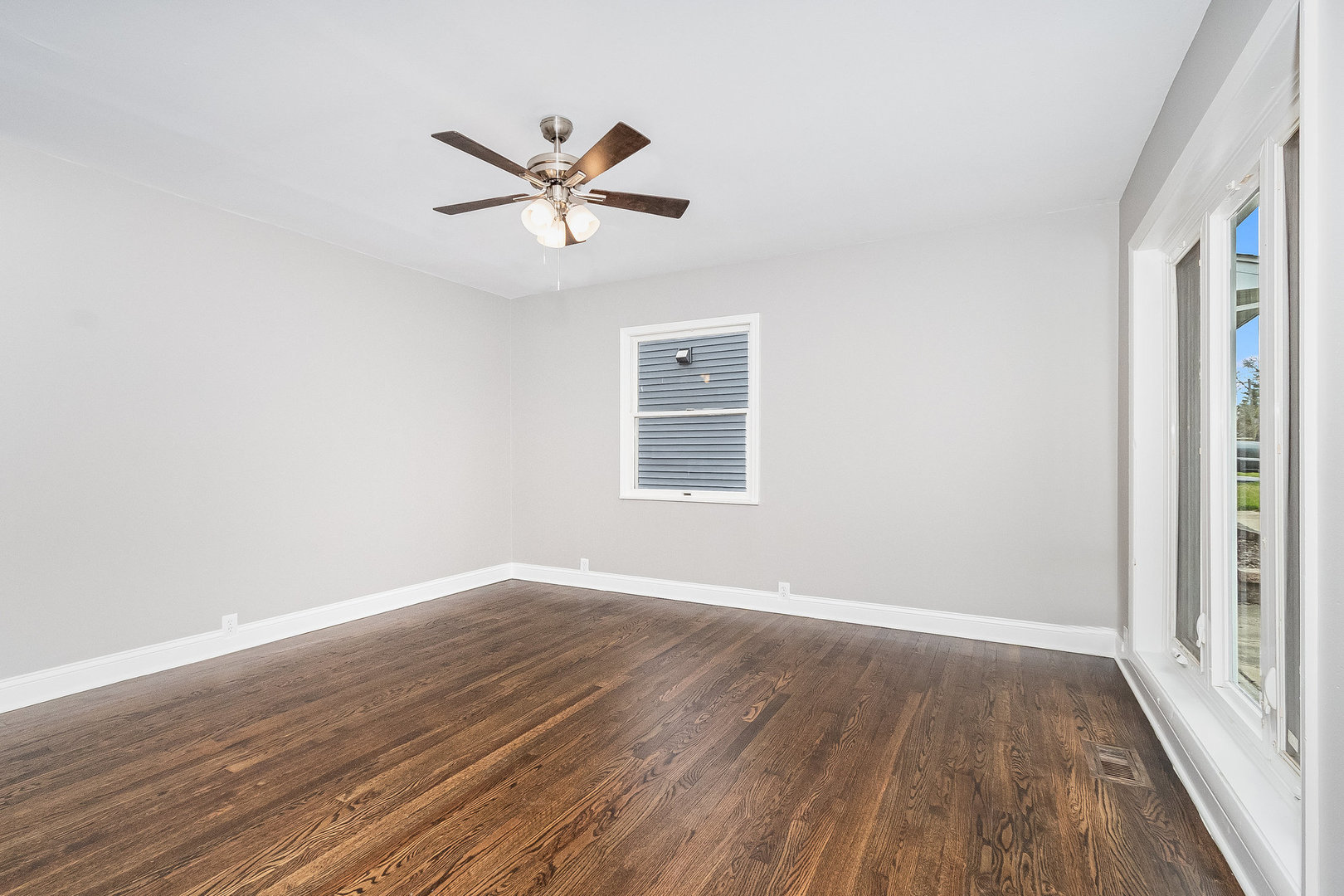 626 Iola Avenue Romeoville, IL 60446 - Photo 9 of 19 a view of a big room with wooden floor closet and windows
