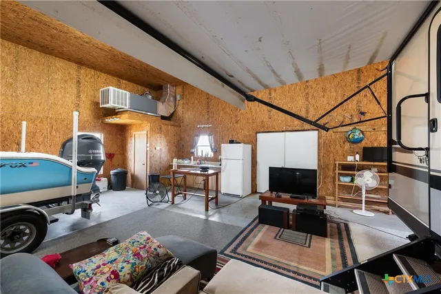 a living room with furniture a flat screen tv and a table