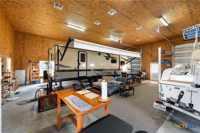 a living room with furniture a pool table and chairs