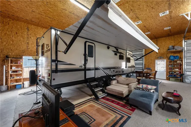 a kitchen with a table chairs a stove and a refrigerator