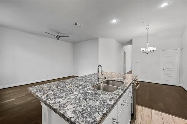 a kitchen with kitchen island a sink stove and refrigerator