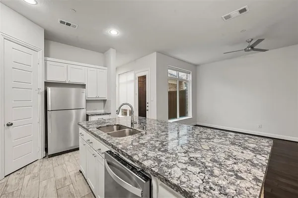 a kitchen with kitchen island a counter top space and stainless steel appliances