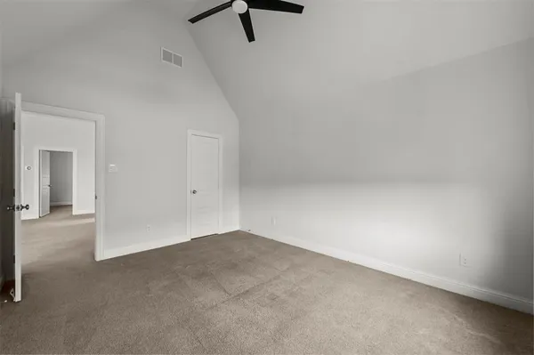 a view of a room with a ceiling fan