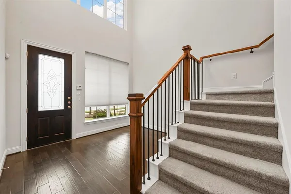 a view of entryway and hall with wooden floor