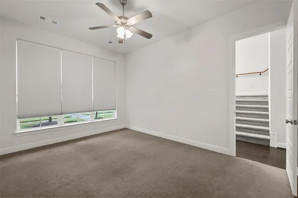 an empty room with a empty space and a ceiling fan