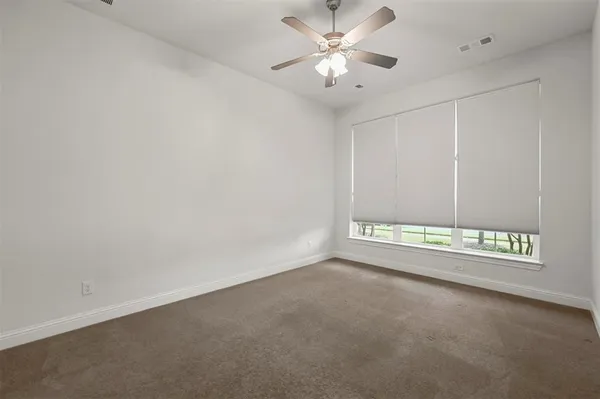 an empty room with a empty space and a ceiling fan