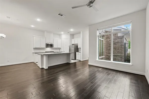 a view of kitchen with cabinets and wooden floor