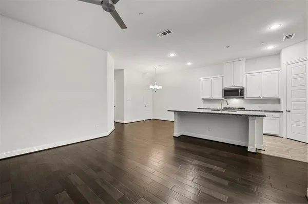a view of kitchen with granite countertop cabinets and wooden floor