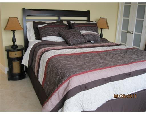 500 South Ocean Boulevard, Unit 1109 Boca Raton, FL 33432 - Photo 58 of 89 a bed sitting in a bedroom next to a lamp