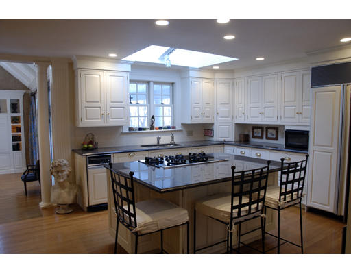 71 Woodcliff Road Wellesley, MA 02481 - Photo 6 of 15 a kitchen with stainless steel appliances kitchen island granite countertop a stove a refrigerator a sink a dining table and chairs