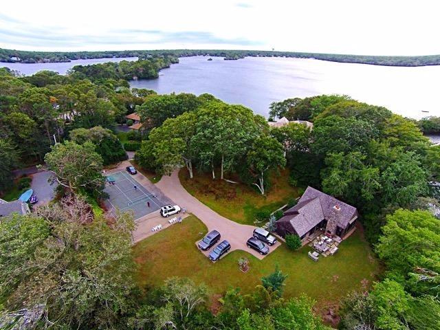 276 Holly Point Road Centerville, MA 02632 - Photo 2 of 14 an aerial view of a house with a garden and swimming pool