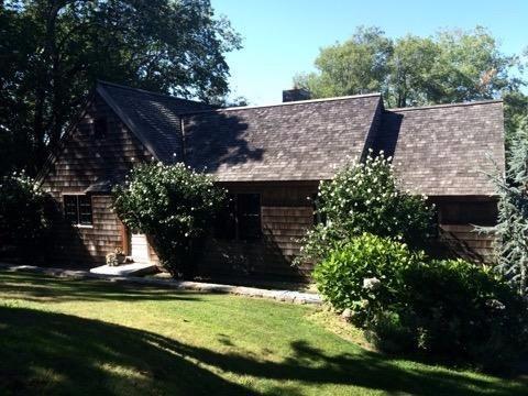 276 Holly Point Road Centerville, MA 02632 - Photo 3 of 14 a view of a house with a yard potted plants and large tree