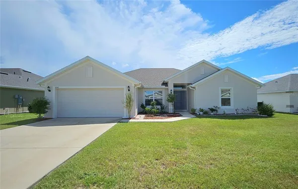 a view of a house with a yard and garage