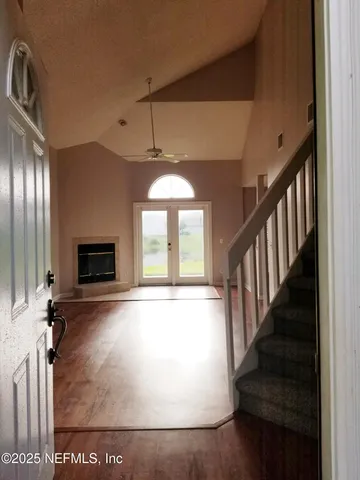 a view of a room with wooden floor