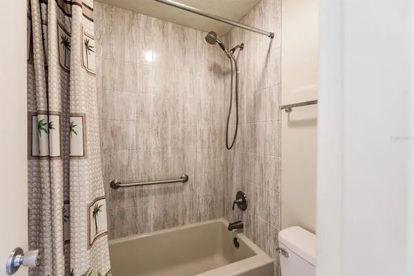 a bathroom with a shower a bathtub and a shower