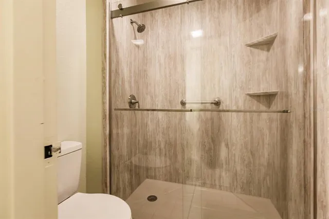 a bathroom with a shower and a toilet
