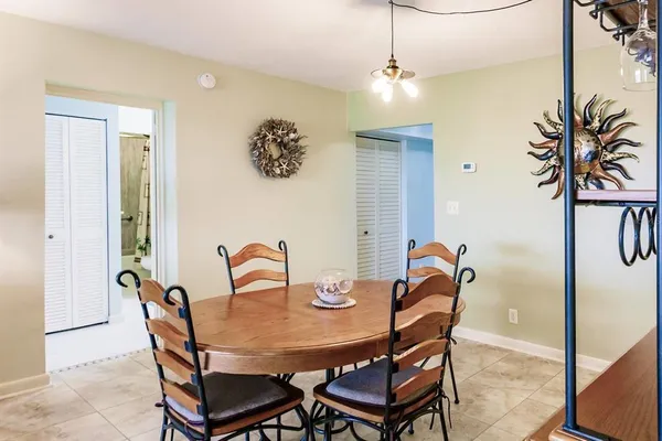 a dining room with furniture and window