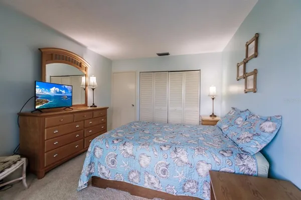 a bedroom with a bed and a television