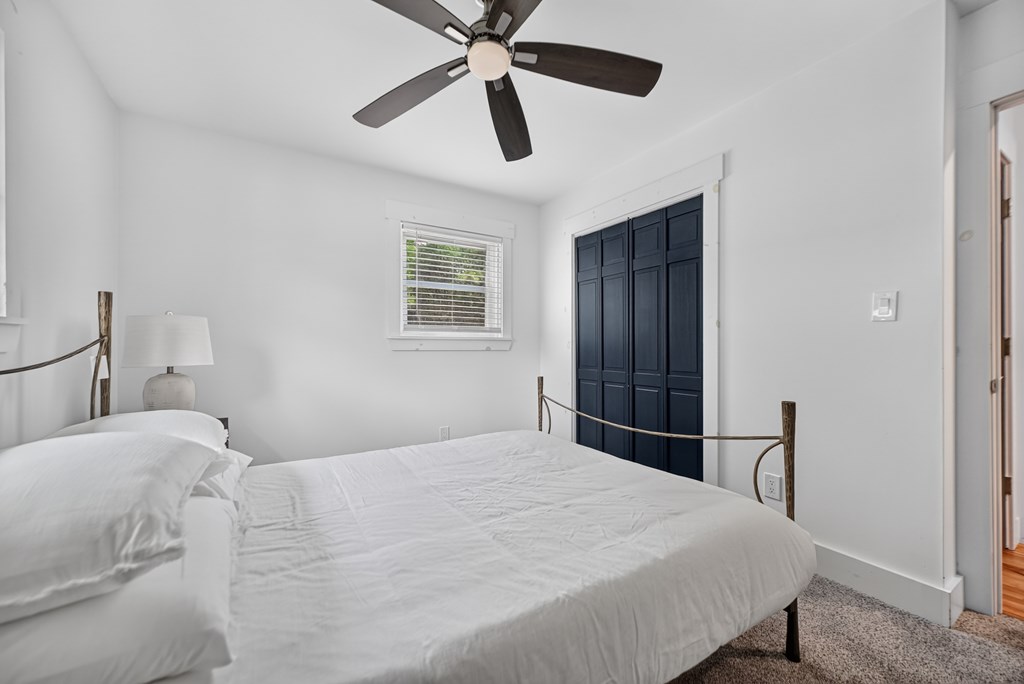 975 Goss Road Epworth, GA 30541 - Photo 56 of 58 a bedroom with a bed and a chandelier