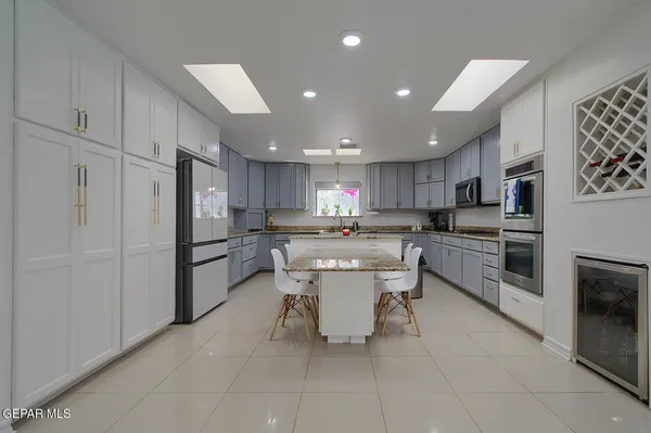 a living room with furniture large window and wooden floor