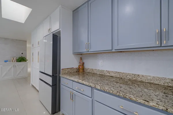 a living room with lots of furniture and kitchen view