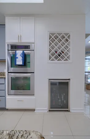 a bathroom with a granite countertop sink a mirror and vanity