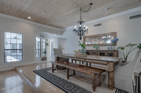 a spacious bedroom with a bed and a chandelier