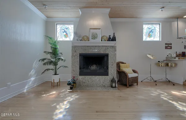 a spacious bedroom with a bed and a fireplace
