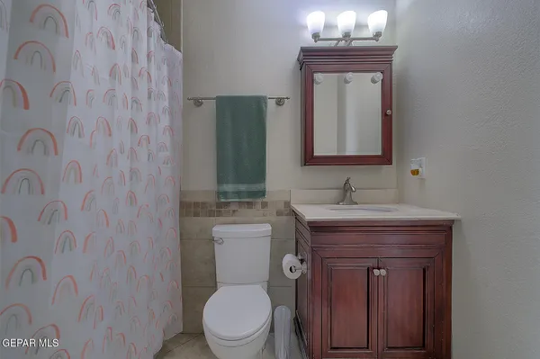 a living room with furniture a floor to ceiling window and a flat screen tv