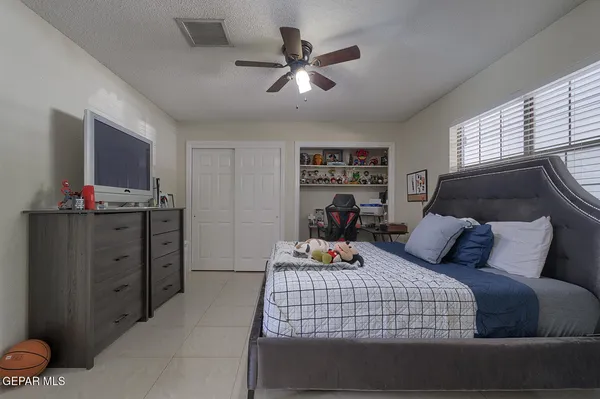 a bed sitting in a spacious bedroom next to a yard