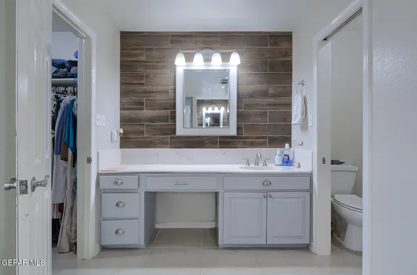 an aerial view of a red and white house with a yard and large trees