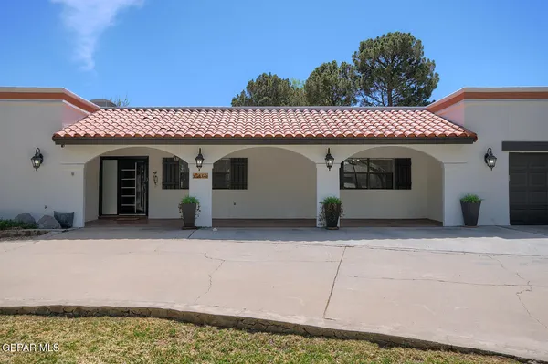 a view of a house with a tree in the yard