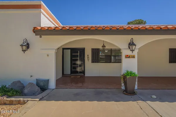 a kitchen with refrigerator and cabinets
