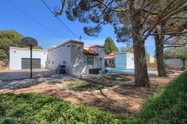 a kitchen with granite countertop a sink stainless steel appliances and white cabinets