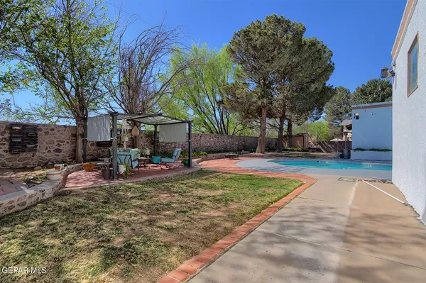 a kitchen with granite countertop a refrigerator and cabinets
