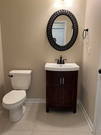 a bathroom with a toilet a sink and a mirror